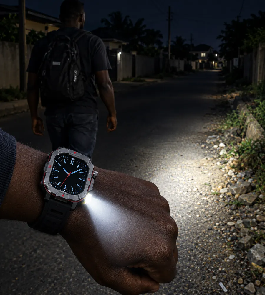 A man walking down a dark street lit by the built-in torch on the Smart Watch Pro